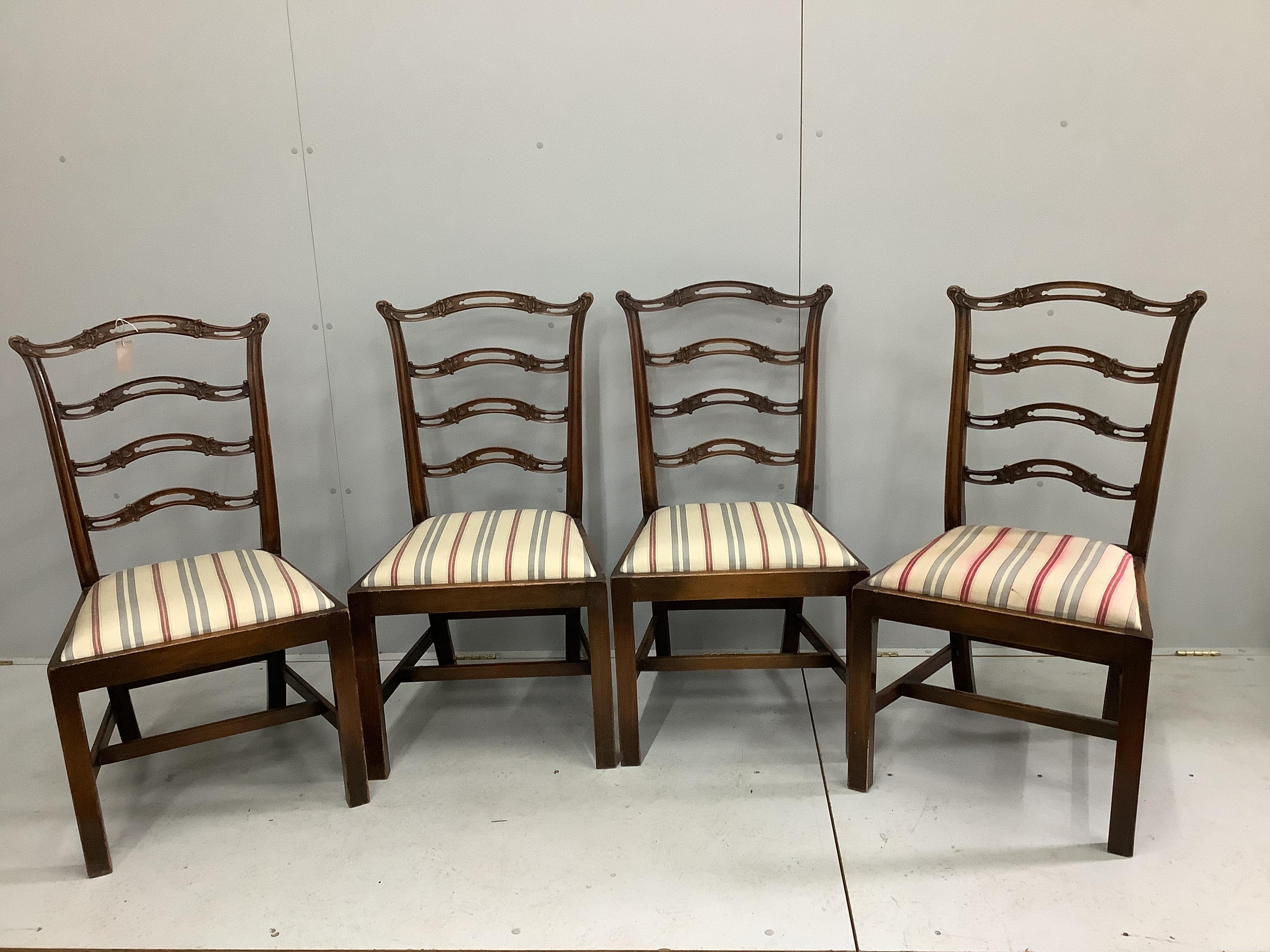 A set of four George III style mahogany pierced ladder back dining chairs (one a/f), width 54cm, depth 45cm, height 101cm